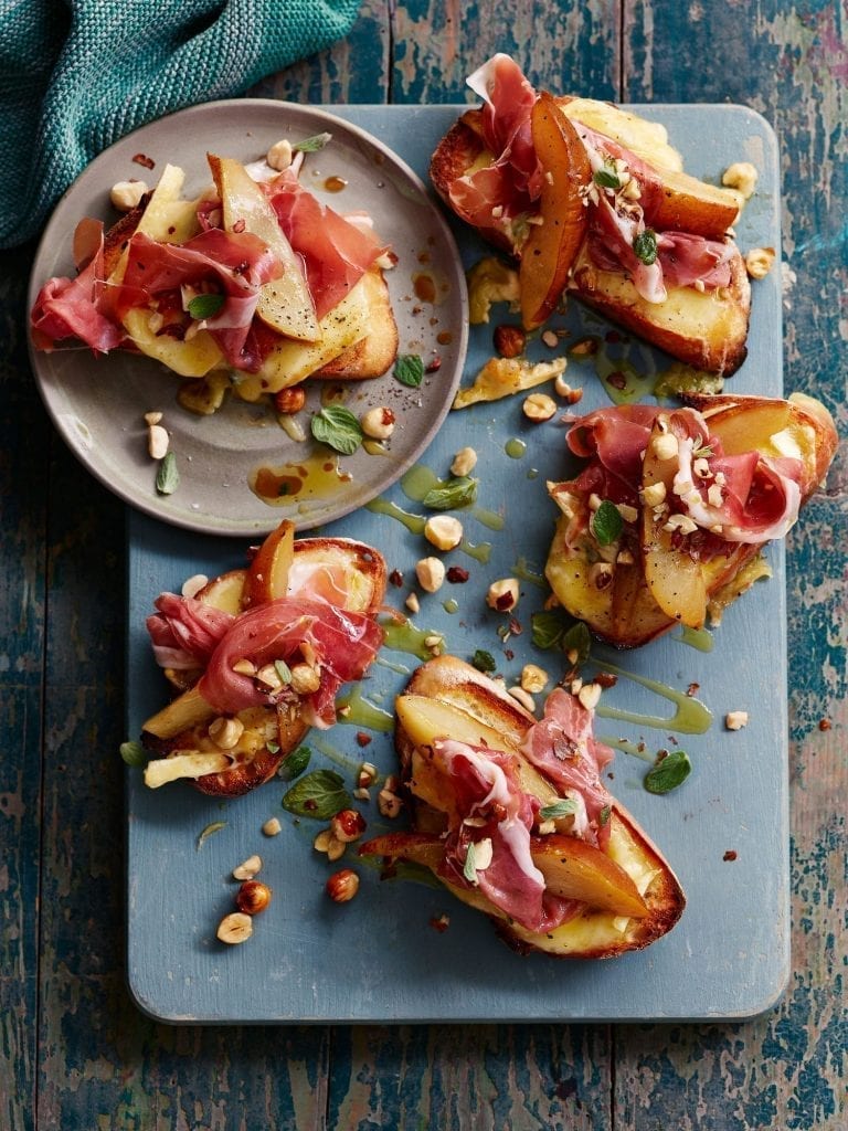Melting cheese toasts with pear, parma ham hazelnut and honey
