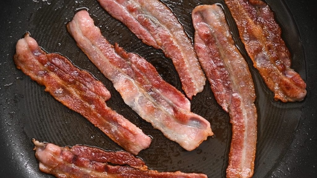 bacon frying in a pan