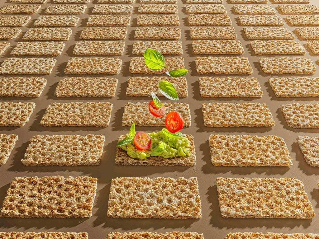 Ryvita graphic food with crushed avocado baby tomatoes basil leaves