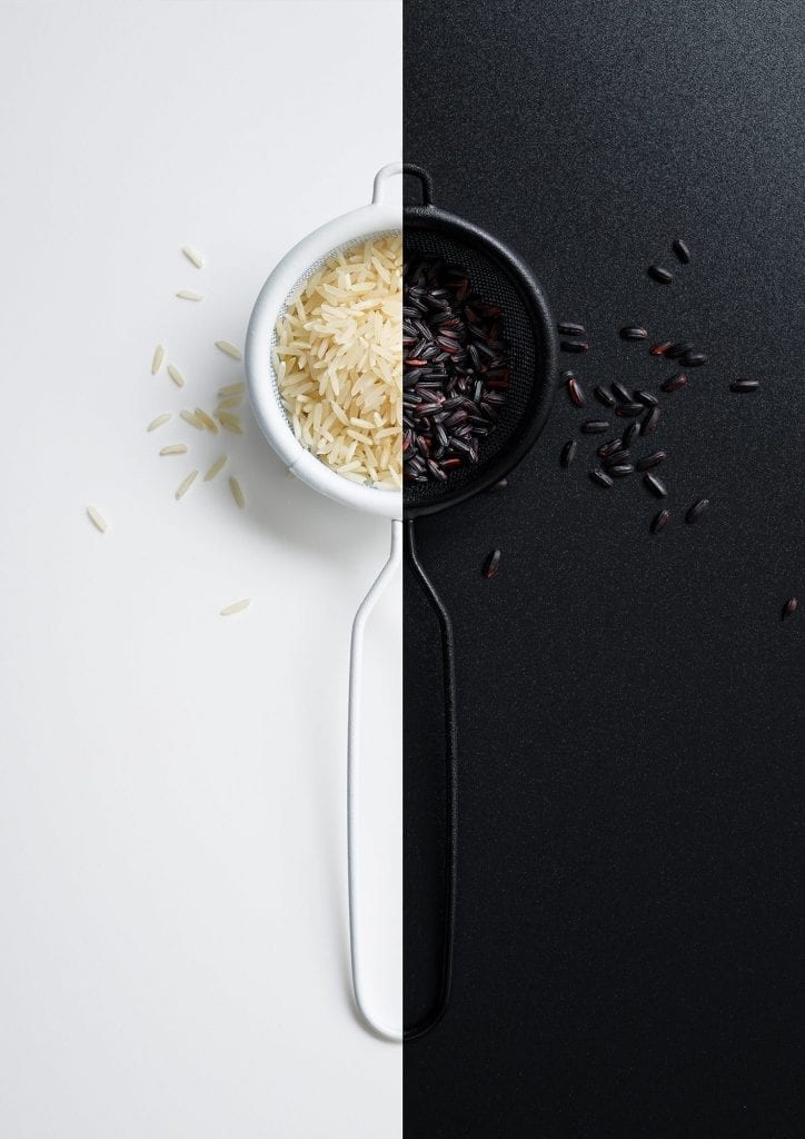 Black and white rice in a sieve