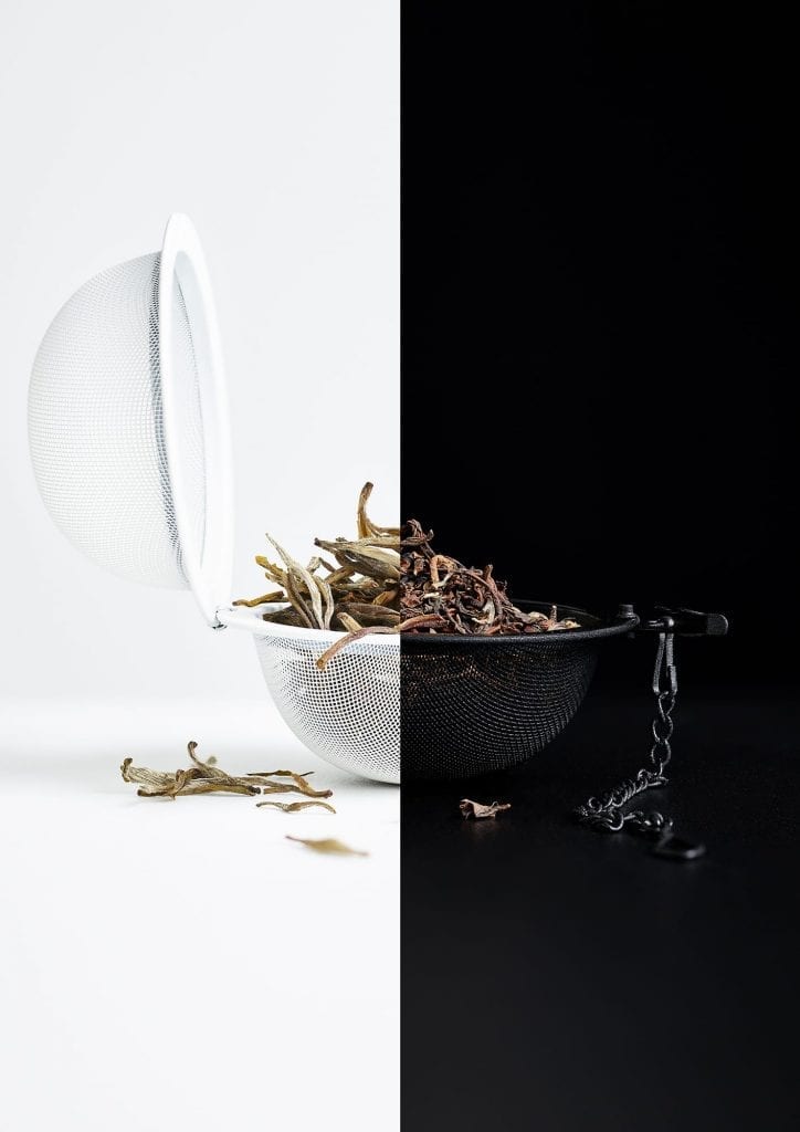 Black and white tea in a tea strainer